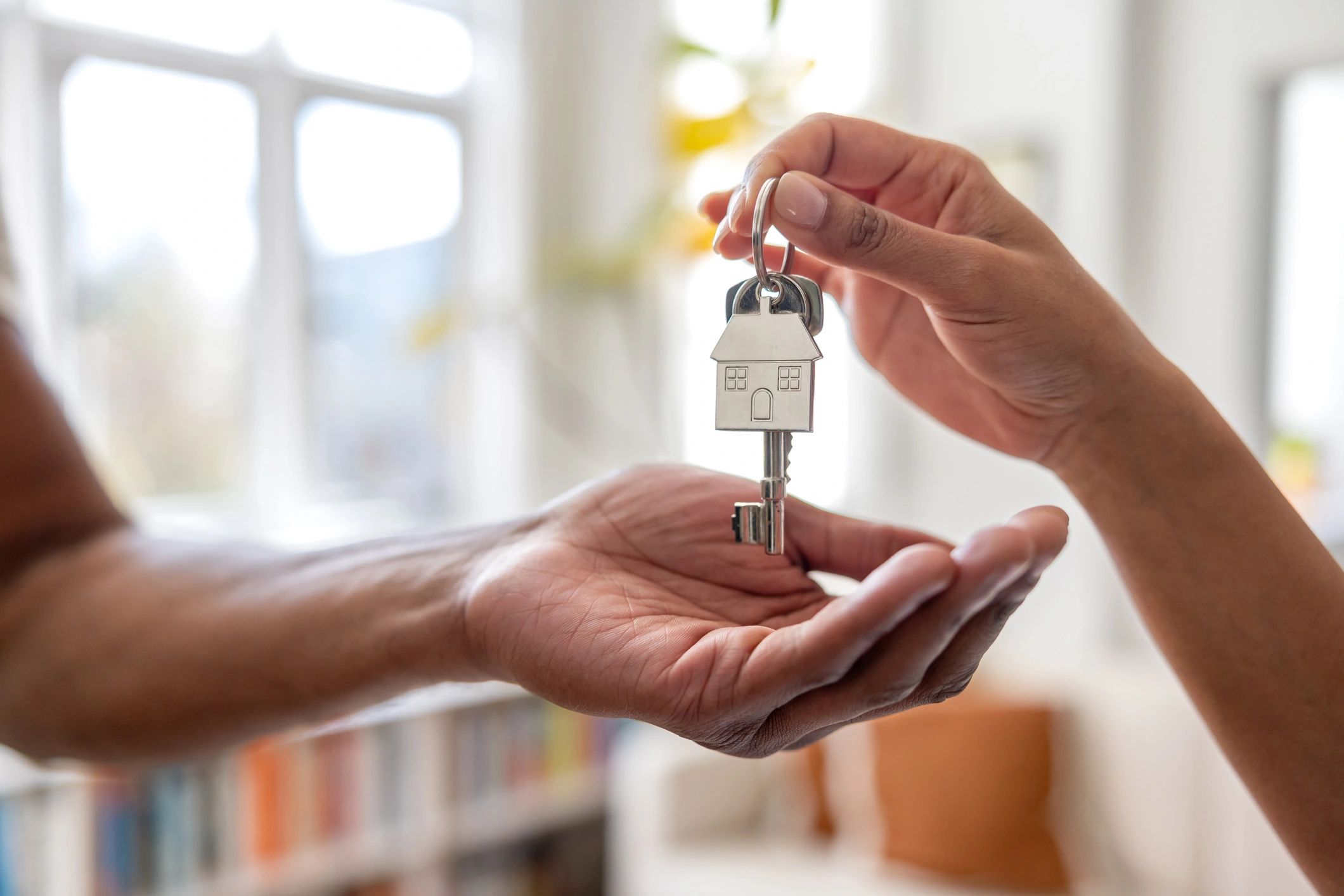 Real estate agent handing new home keys to a buyer